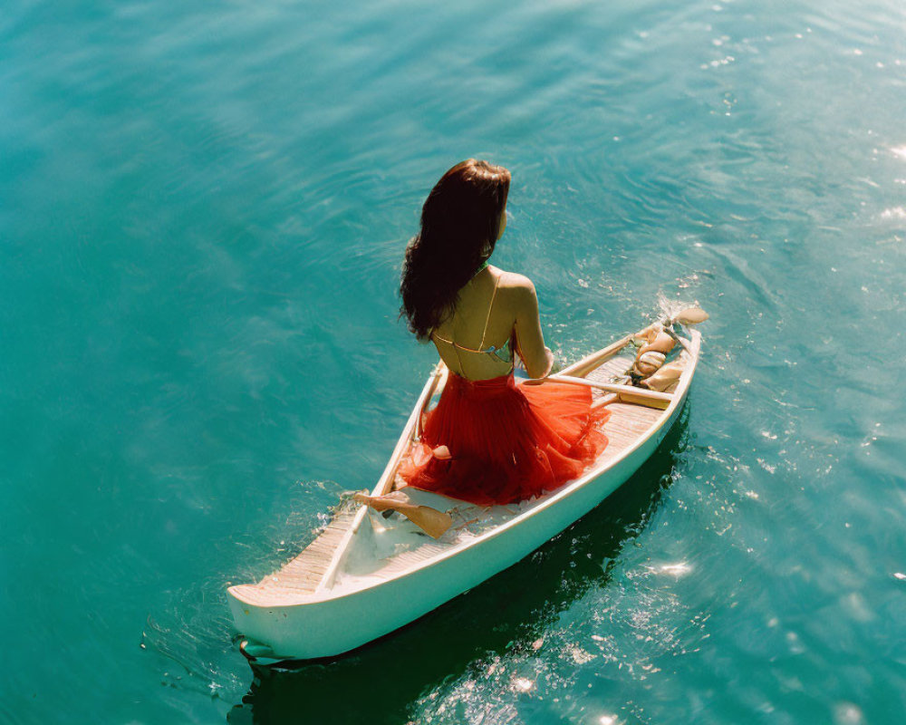 Woman in Red Dress Relaxing on Canoe in Tranquil Lake
