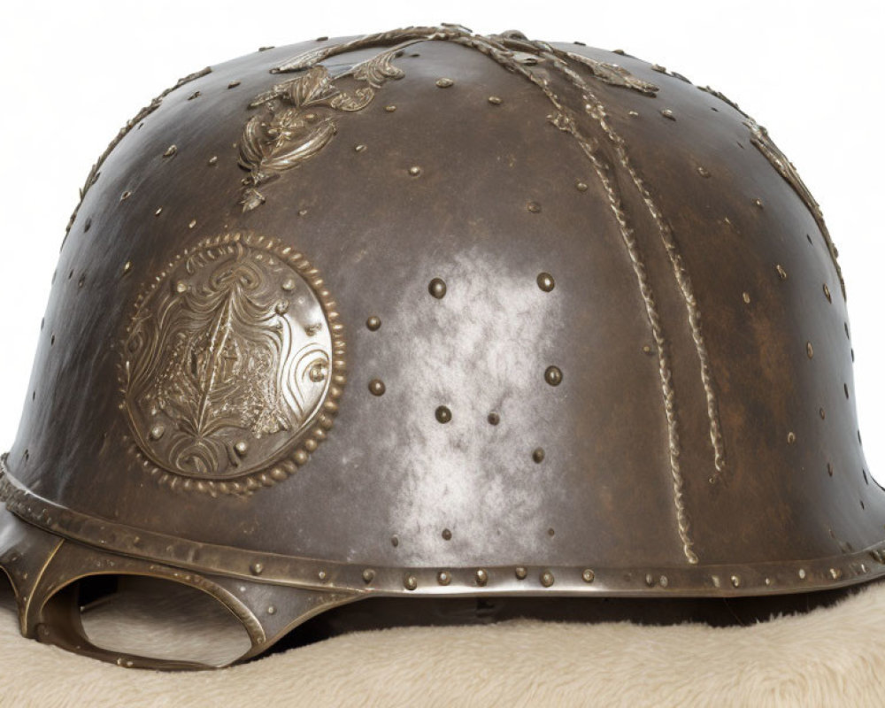 Antique Metal Helmet with Embossed Decorations and Rivet Details