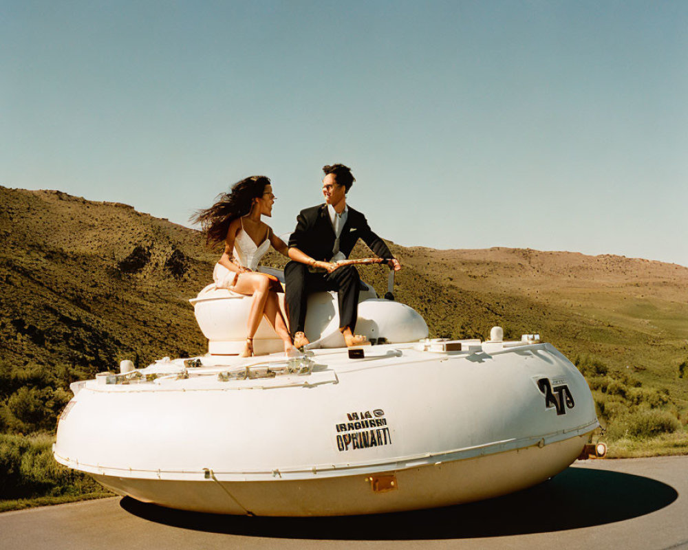 Couple in formal attire on white submarine in sunny landscape