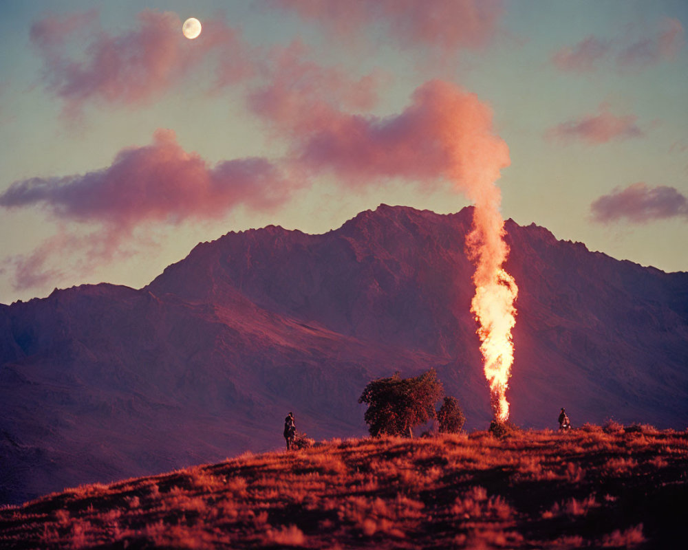 Mountainous backdrop with towering fire plume at twilight