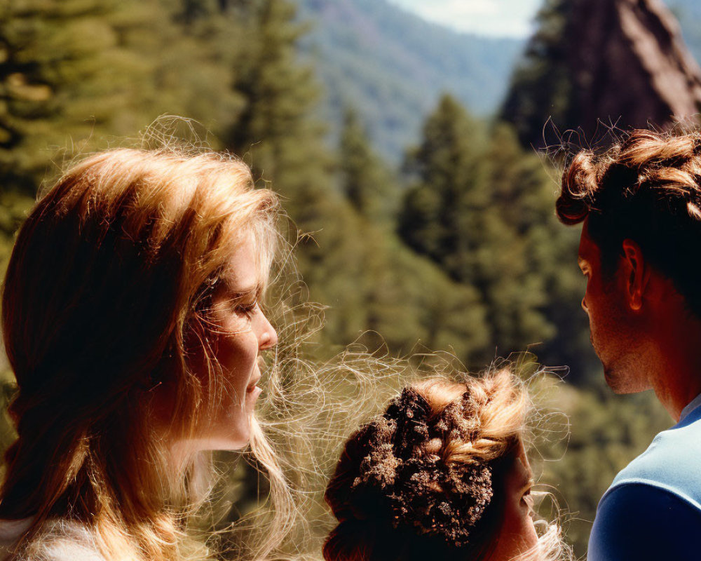 Scenic forest with towering rock formations and three people under clear blue sky
