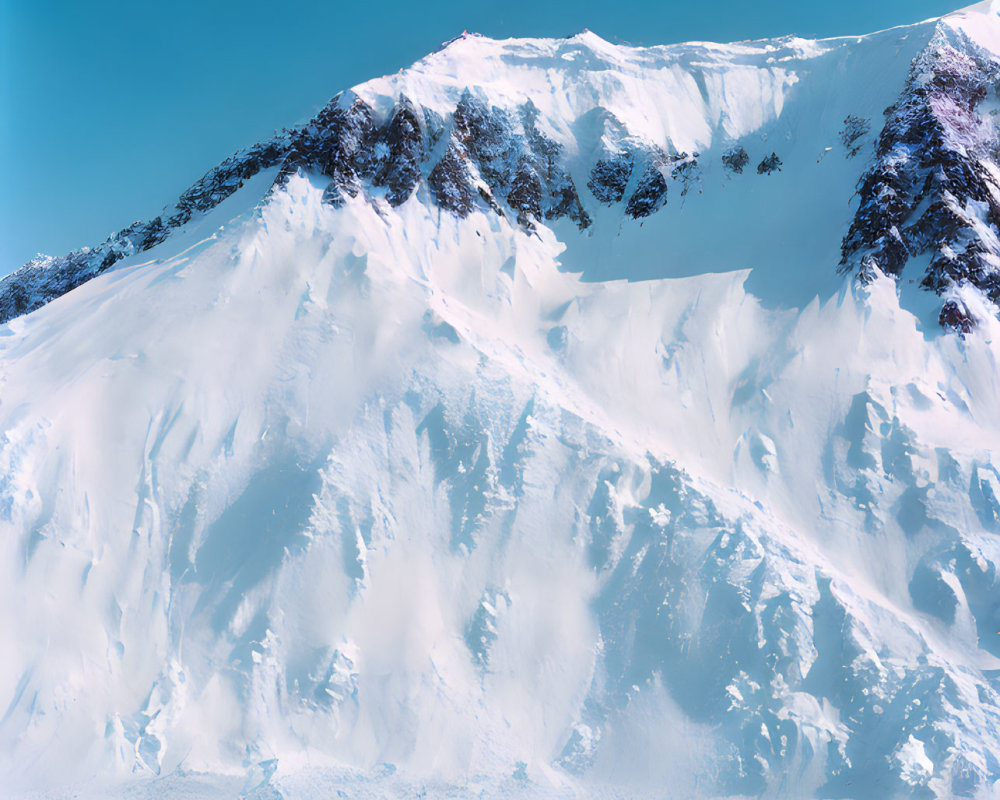 Group of climbers trekking snowy landscape near towering mountain