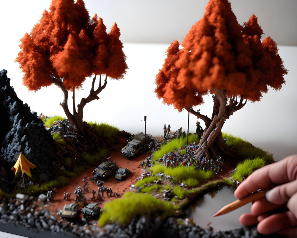 Miniature battle scene diorama with soldiers, tanks, orange trees, and hand holding pencil
