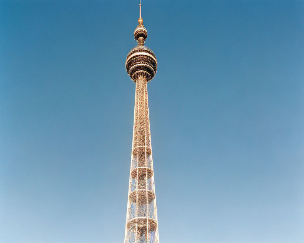 Tall metal structure with spherical observation deck under clear blue sky