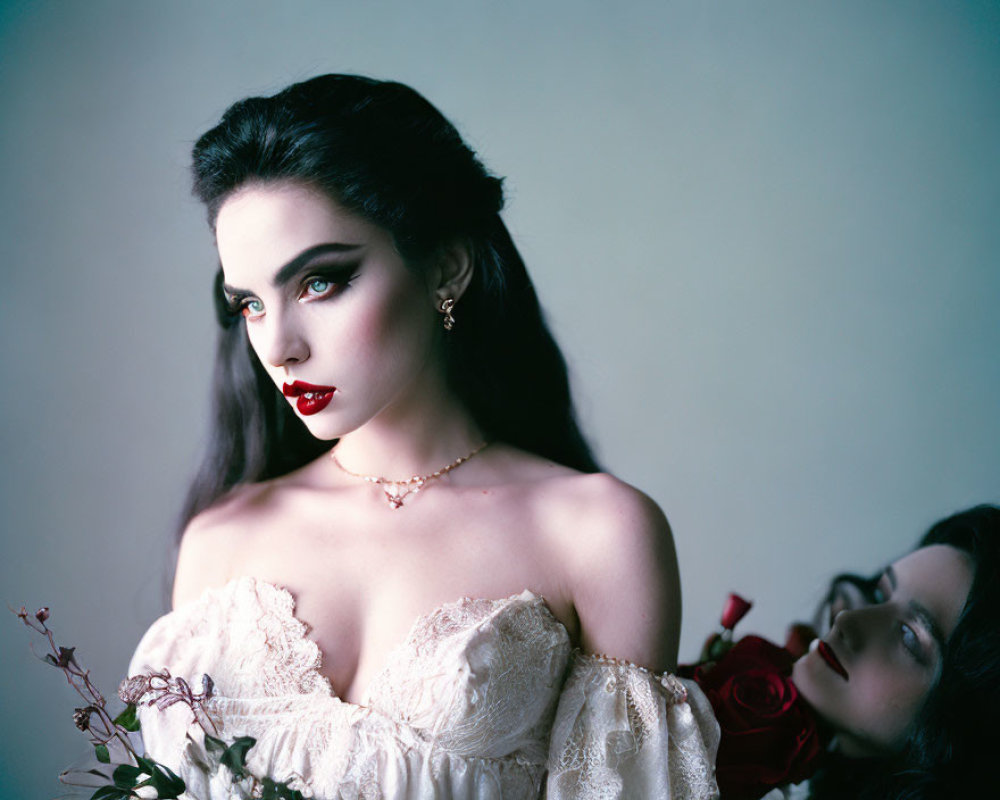 Dark-haired woman in off-shoulder dress with red lipstick holding a red rose gazes afar