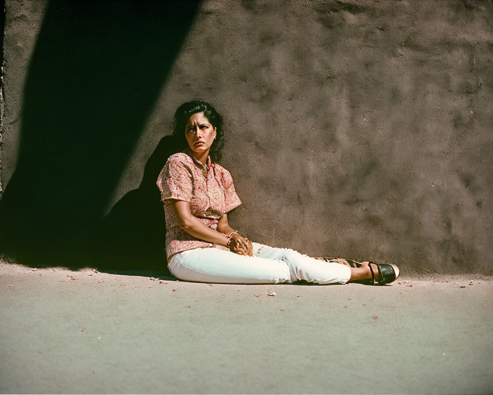 Woman sitting in shadow with sunlight half-illuminated scene