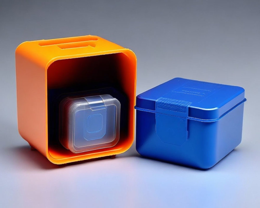 Plastic nesting storage containers: orange large, blue small, on grey background