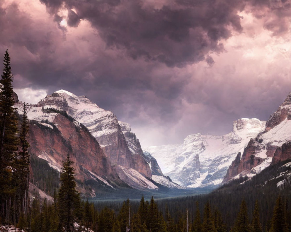Snow-capped peaks in dramatic mountain landscape under stormy purple sky.