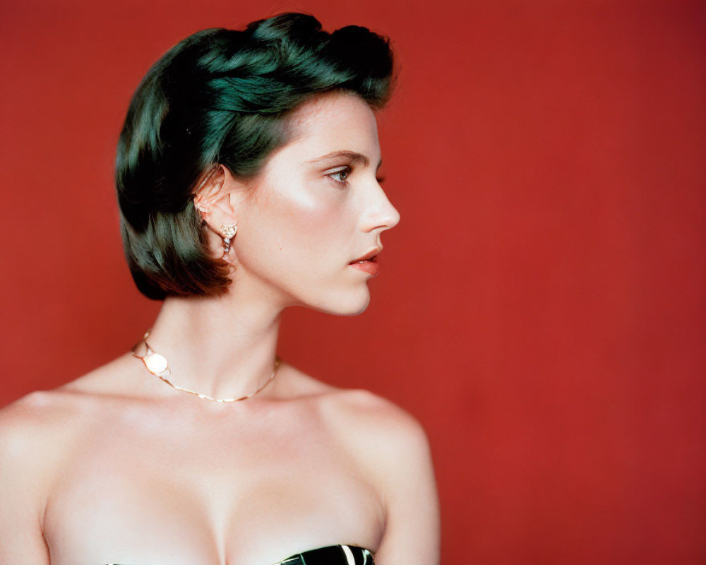 Vintage Hairstyle Woman in Black Dress and Jewelry on Red Background