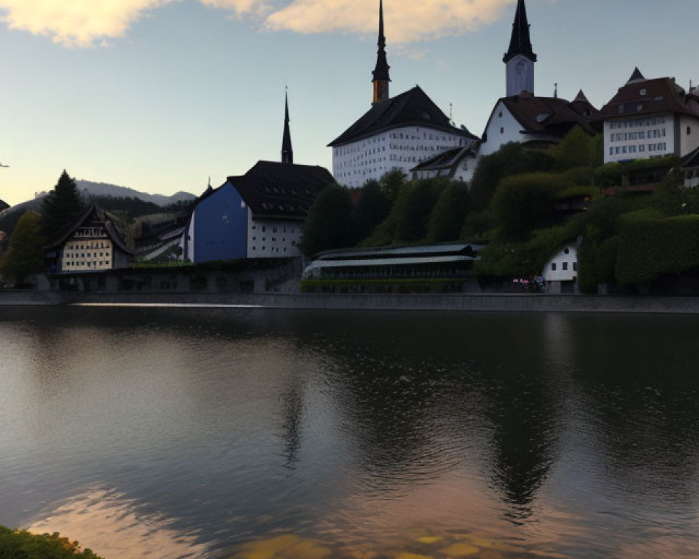 Tranquil river with old European buildings and spires reflecting in sunset sky