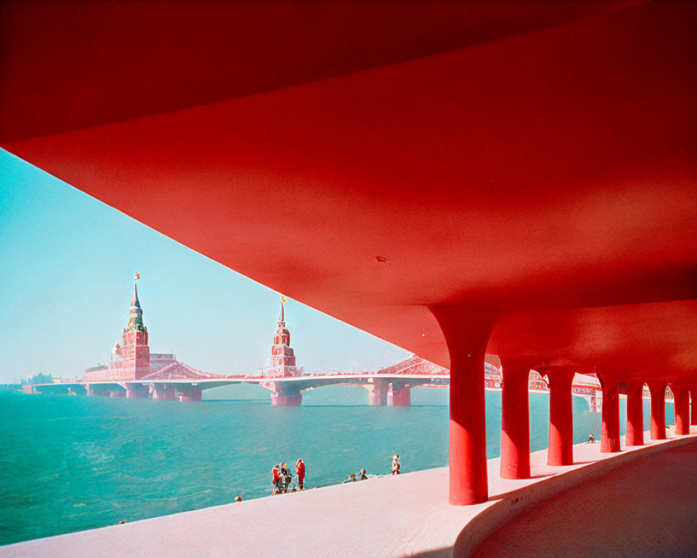 Bright red bridge with arches over river, cityscape, and people walking below