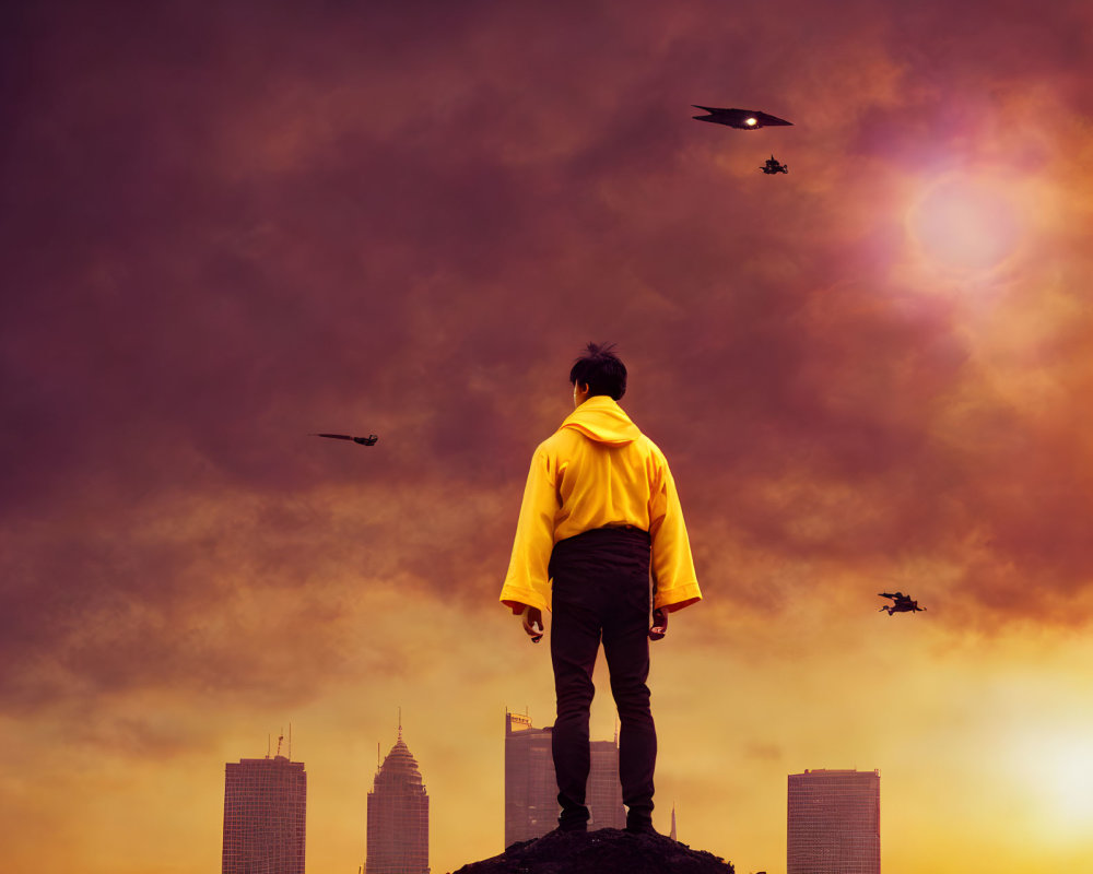 Person in yellow jacket on hill gazes at city skyline under orange sky with drones.