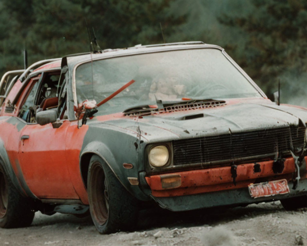 Old Red Car with Missing Bumper on Dusty Road