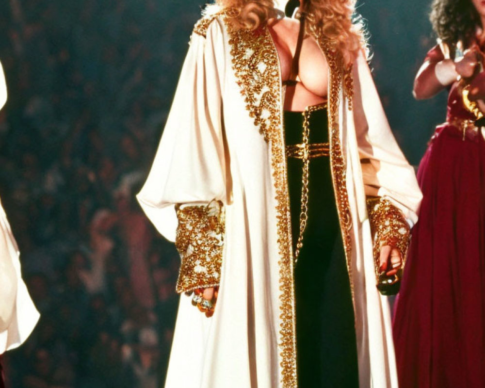 Performer in Gold-Trimmed Cloak and Corset on Stage
