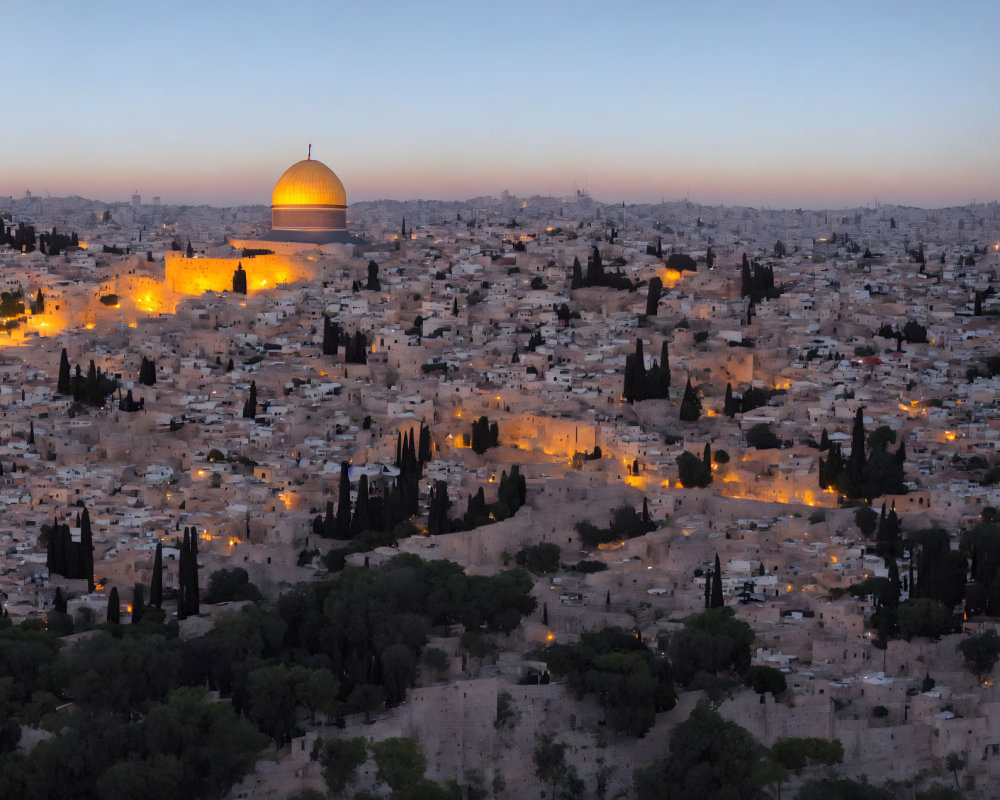 Cityscape with illuminated golden dome and sprawling buildings at dusk