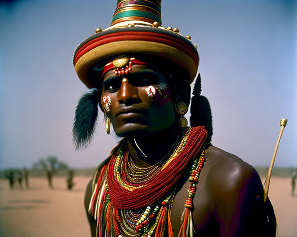 Indigenous person in traditional attire with tall headdress and ornaments