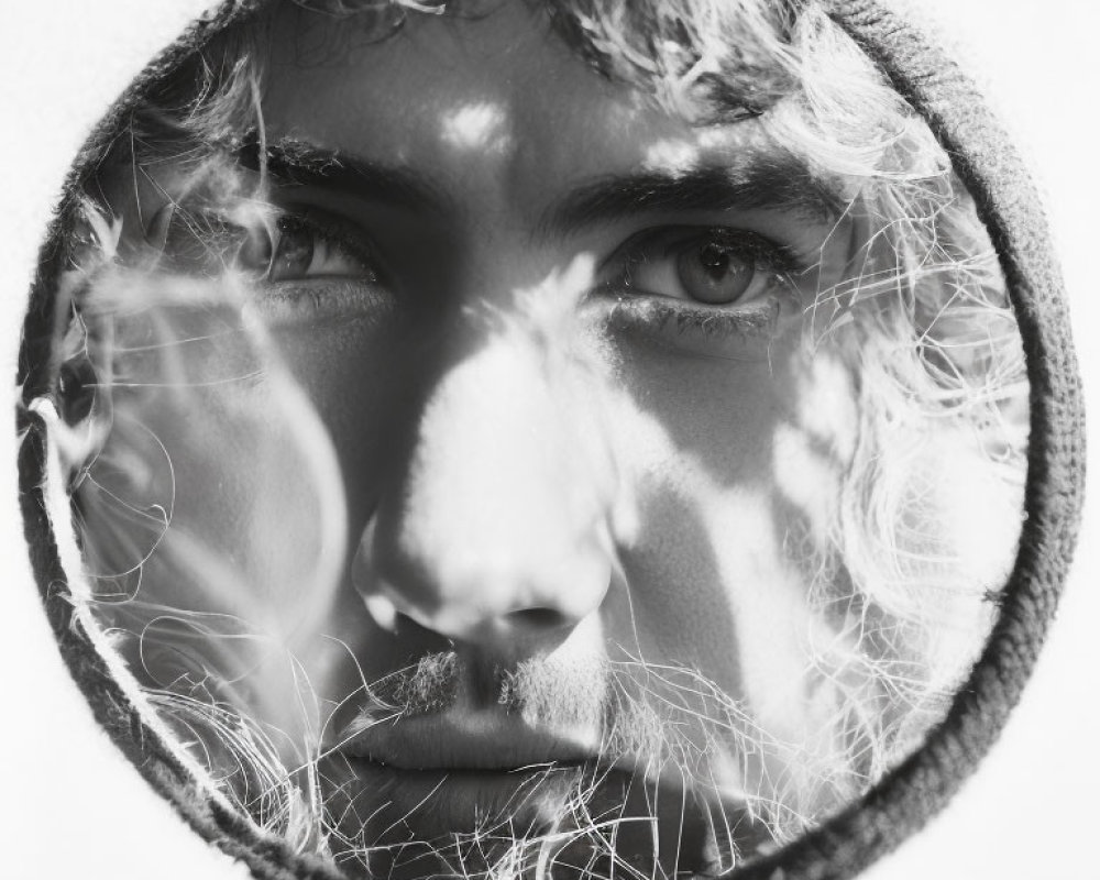 Person's Face Close-up Framed by Light and Shadows