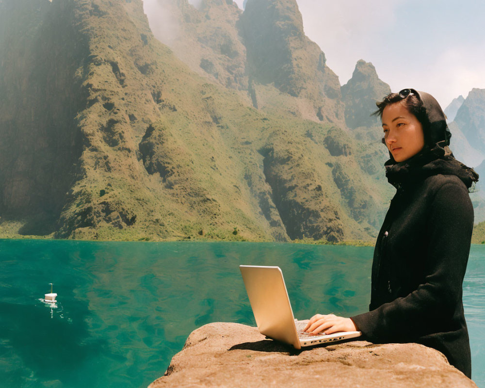 Person in Black Outfit Works on Laptop by Mountain Lake on Sunny Day