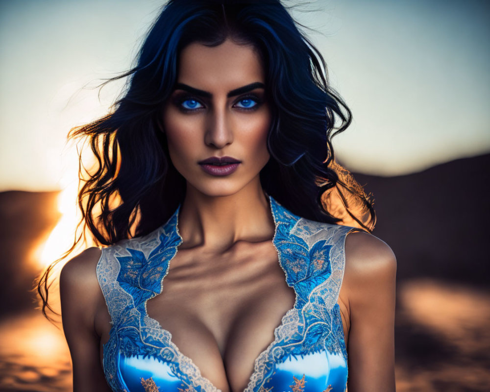 Woman with Striking Blue Eyes and Dark Wavy Hair in Blue Lace Attire