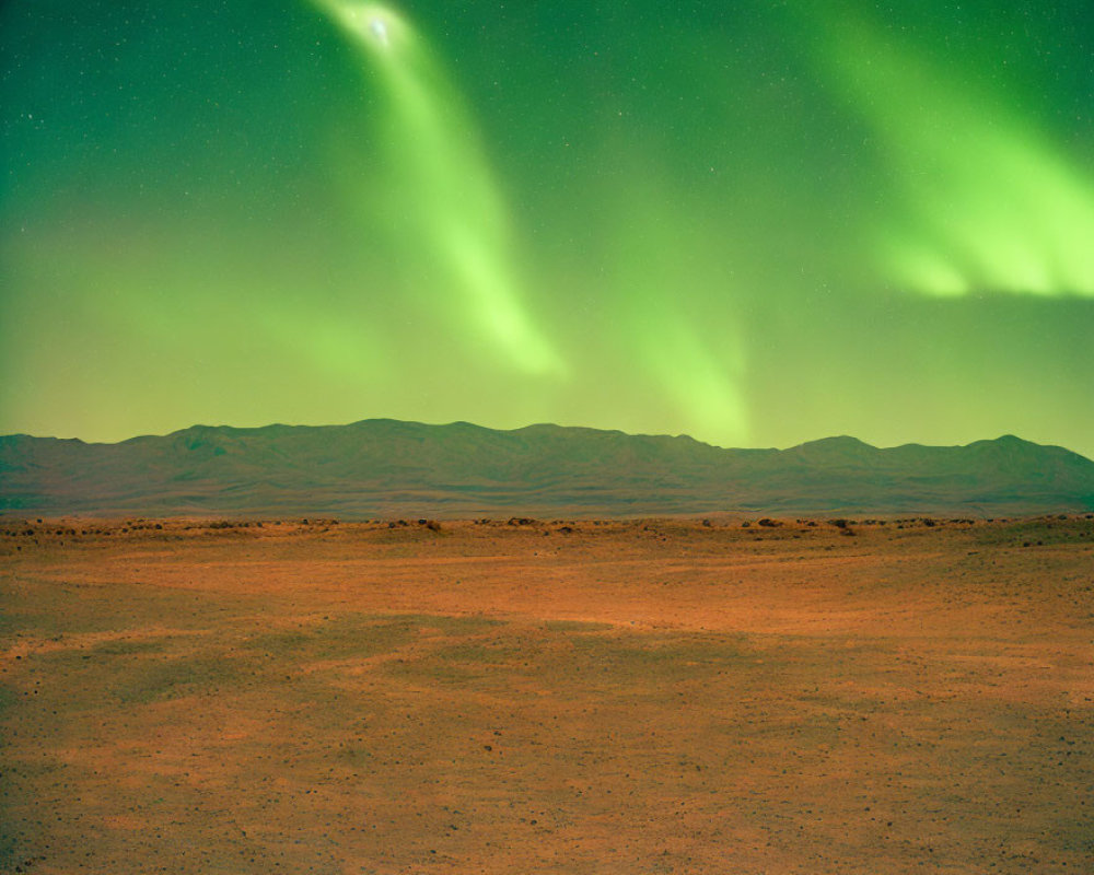 Barren desert landscape at night with vibrant green aurora borealis sky