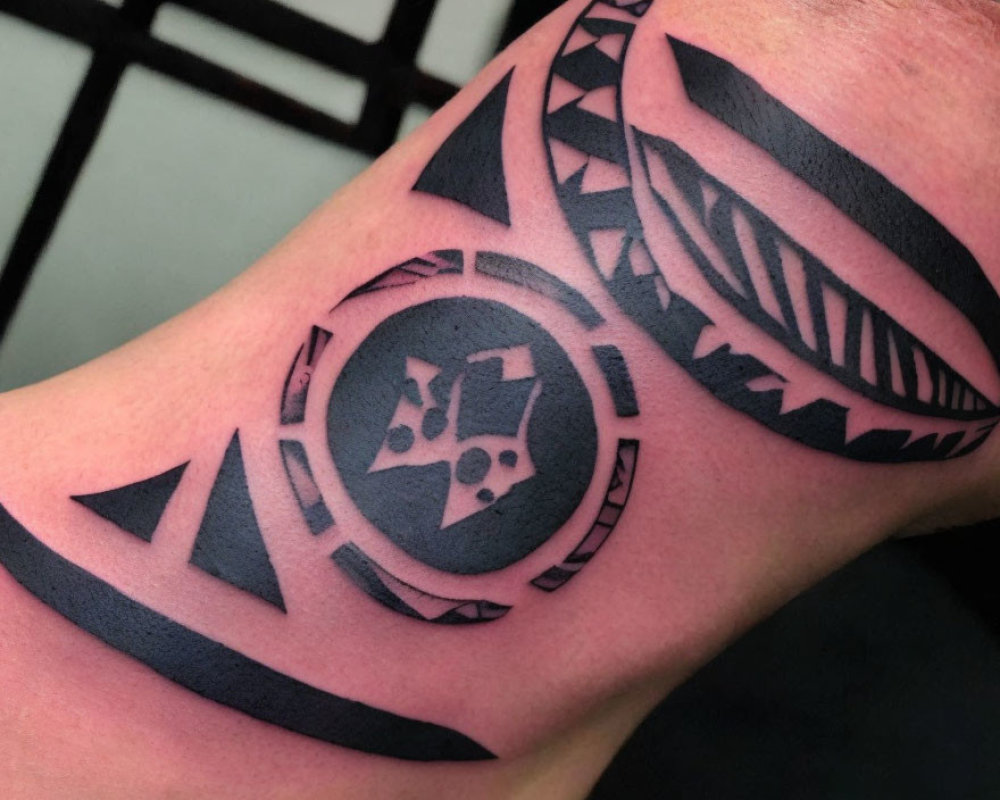 Polynesian-style Arm Tattoo with Bold Geometric and Tribal Designs