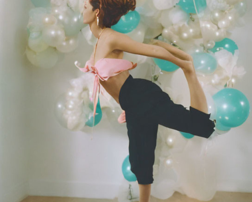 Woman in Dynamic Pose Surrounded by Balloons